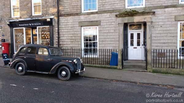 Black Austin 7 car parked outside the original Skeldale House from the BBC TV series that was filmed in The Yorkshire Dales village of Askrigg